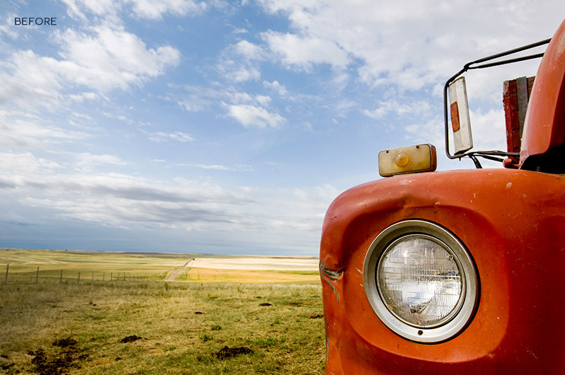 Free-Photoshop-Action-Collection closeup image of a red car's headlight in a scenery
