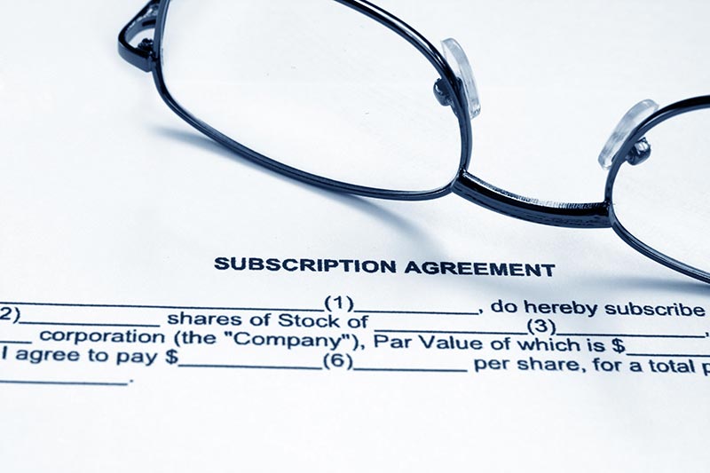 Subscription agreement Preview Subscription agreement text written on paper and glasses