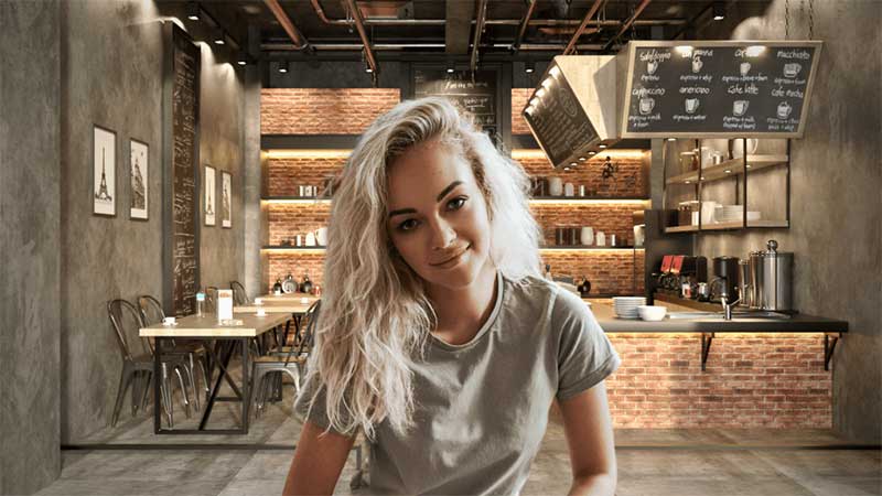 A women sitting with a living room background behind her