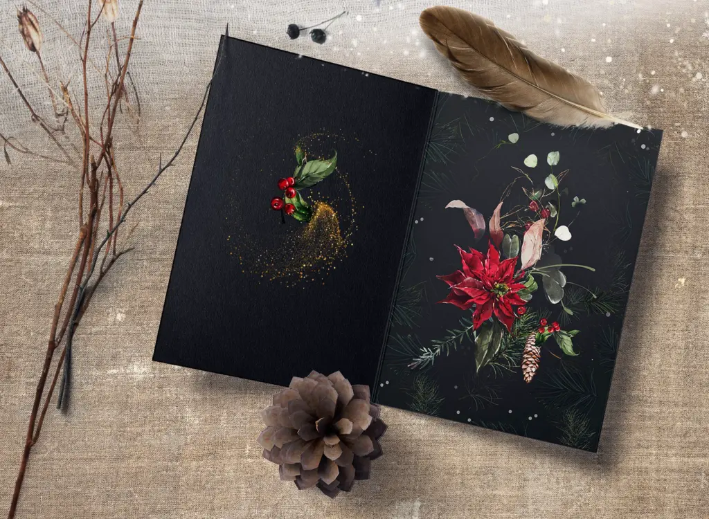 An open black card is shown with a poinsettia and pine design on one side and a simple holly arrangement on the other.