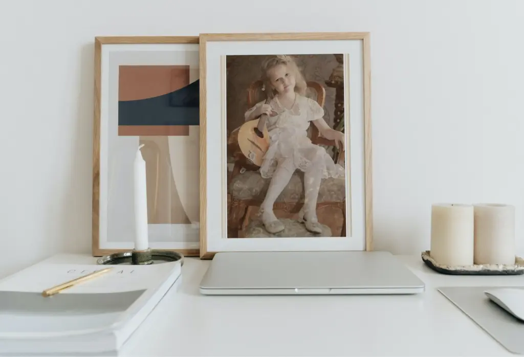 A mockup of a gold picture frame against a dark background, showcasing a vintage botanical print.