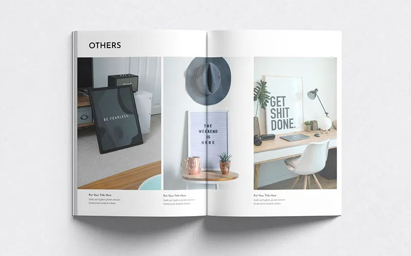A close-up of a two-page spread from the portfolio template. The left page has an image of a 'Be Fearless' framed print, while the right page shows a desk with a 'GET SHIT DONE' poster. The top of both pages is titled 'OTHERS'.
