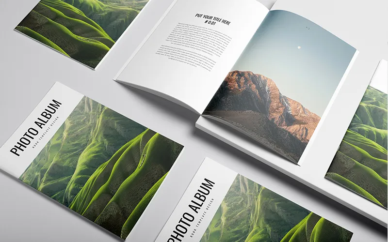 Open and closed photo albums with landscape pages