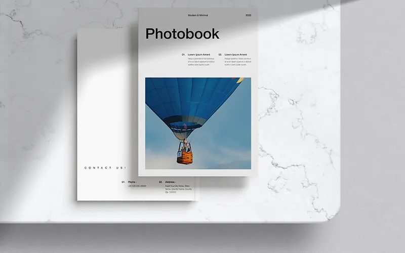 Photobook with hot air balloon cover and contact info page in minimalist style