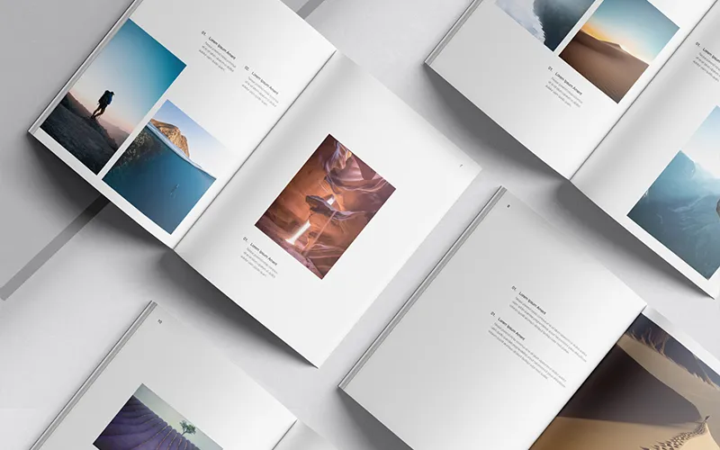 Open photography books showcasing vibrant landscapes and minimalist captions