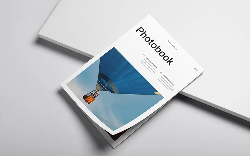 Minimalist photobook cover with hot air balloon image and themed sections: Travel, Nature, Architecture