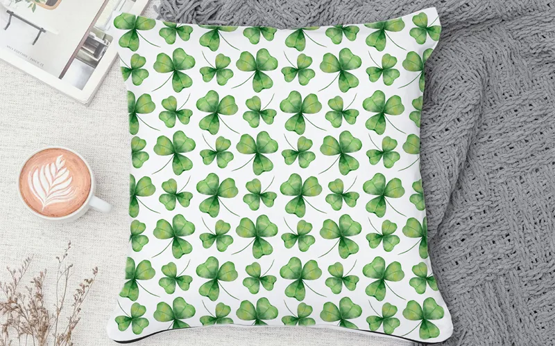 A decorative pillow cover showcasing a seamless watercolor shamrock St Patricks Day pattern.
