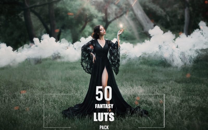 woman in a black long dress with a trailer and lace sleeves. magic. witchcraft. leg, slender figure.stealing soul, spirit hunter, fire in hands, sparks, mysteries, smoke, forest, art photo. sun light.