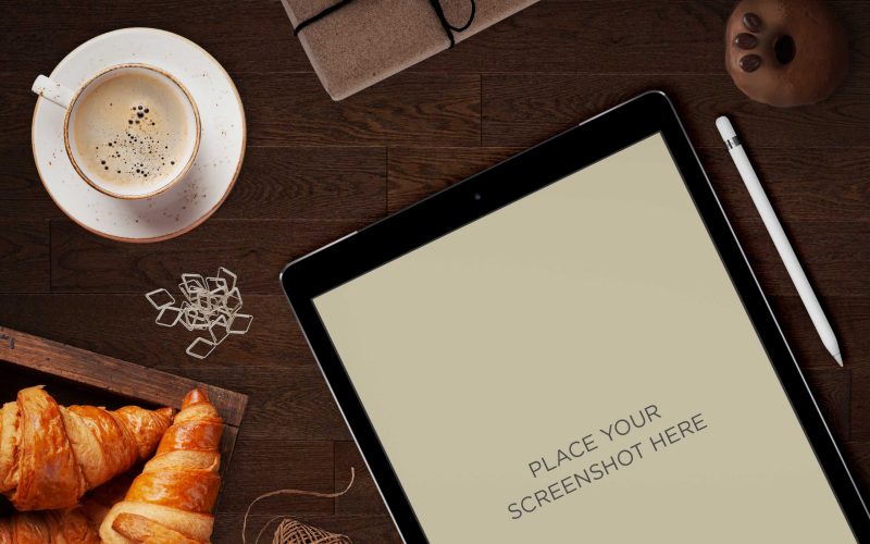 table mockup free download with coffee and a tablet places on a table with other breakfast things